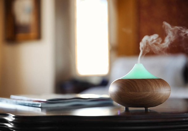 Aroma oil diffuser on wooden table  - Zdjęcie, obraz