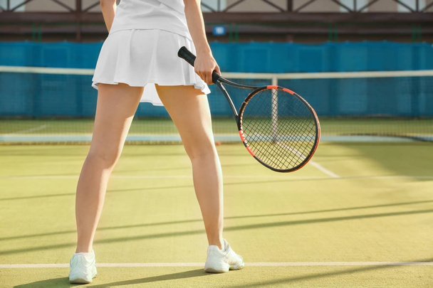 Young woman playing tennis on court - Fotoğraf, Görsel