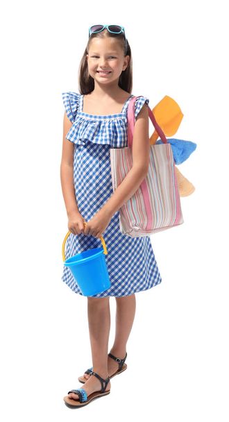 Cute little girl with beach accessories on white background. Summer vacation concept - Foto, imagen