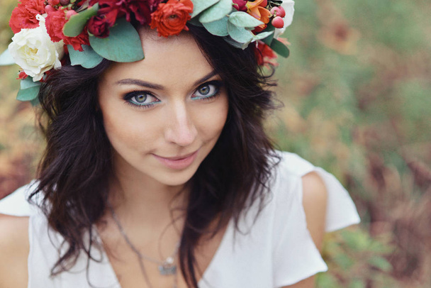 autumn portrait of romantic woman with flowers in her hair in a wreath - Photo, Image