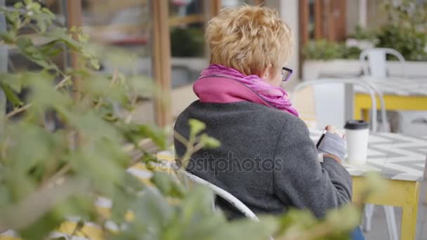 Adult woman with coffee and smartphone - Footage, Video