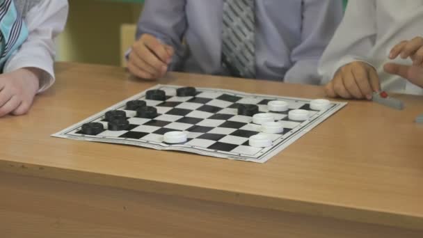The children play checkers in kindergarten indoors - Video