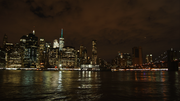 New York City cityscape skyscrapers skyline night bridge East River view Manhattan water reflection USA East Coast, district panorama view traffic areal view big city, time lapse, 4k - Footage, Video