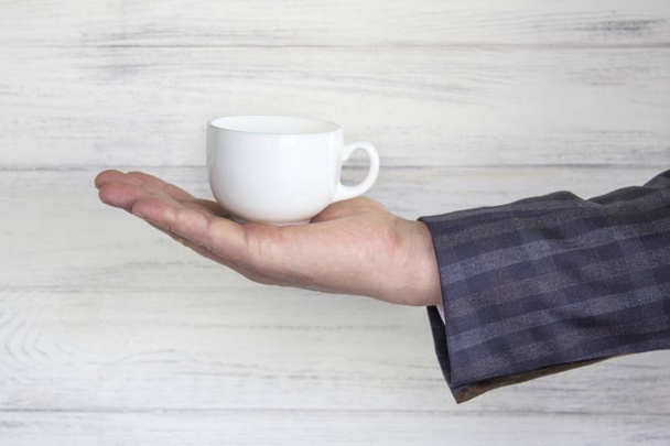 cup in the businessman's hand. - Photo, Image