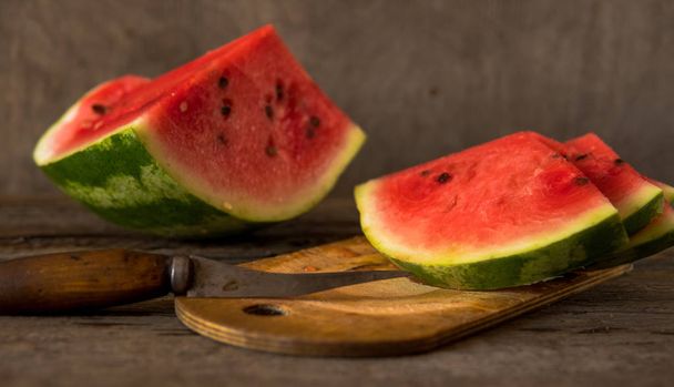Wassermelonenscheiben auf dem Holztisch. frische rote Wassermelone. Das Problem ist nur, dass es sich dabei um ein Problem handelt, das wir nicht lösen können. - Foto, Bild