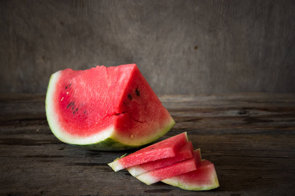 Watermelon on the wooden background. Organic watermelon - Foto, afbeelding