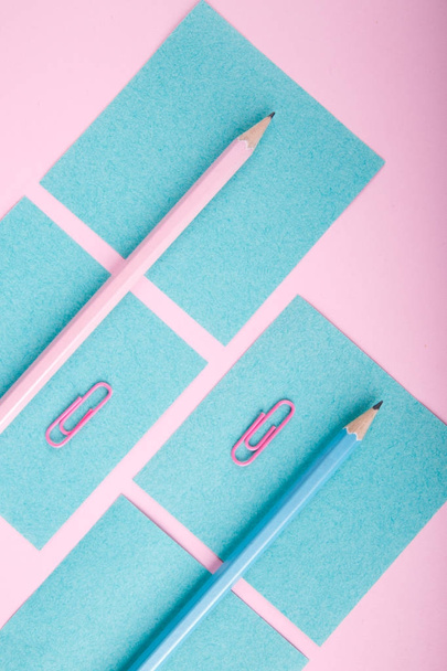 A close-up of a blue and pink office on a bright pink background. View from above. Blue and pink office. A lot of school objects. - Foto, imagen