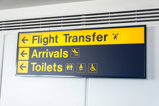 Black and yellow flight transfer, arrivals and toilets sign - Photo, Image