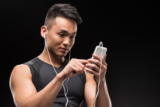 man in earphones using smartphone - 写真・画像