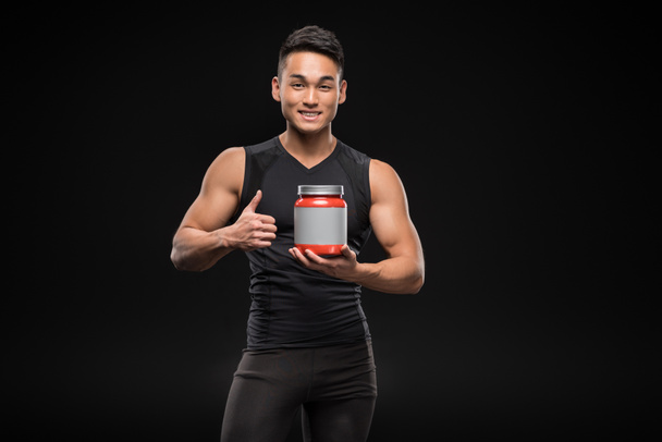 muscular man with sport nutrition - 写真・画像