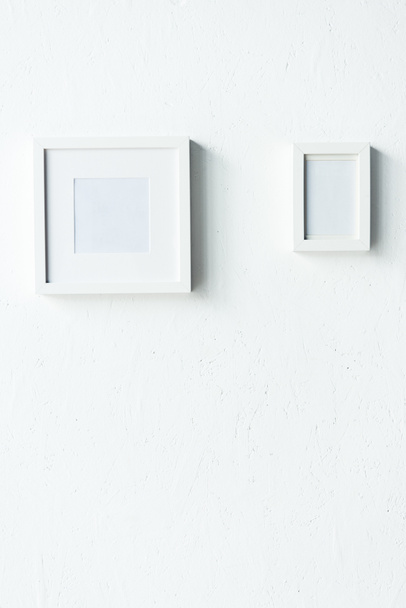 empty photo frames hanging on wall - Zdjęcie, obraz