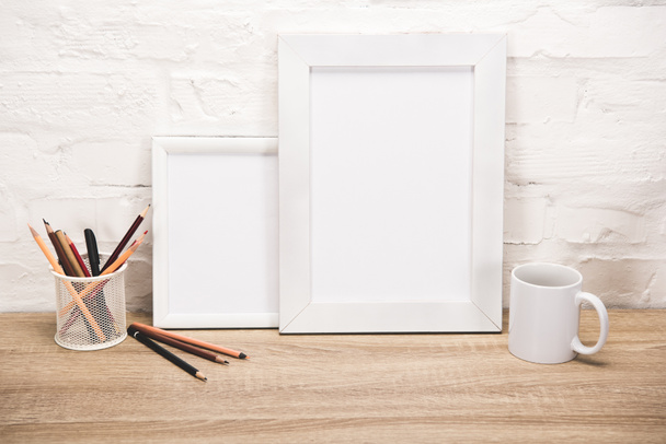 photo frames and coffee cup on tabletop - Foto, imagen