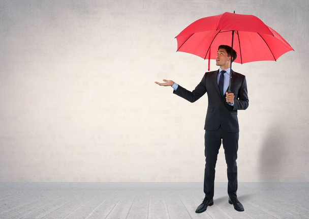 Businessman under umbrella in room - Foto, immagini