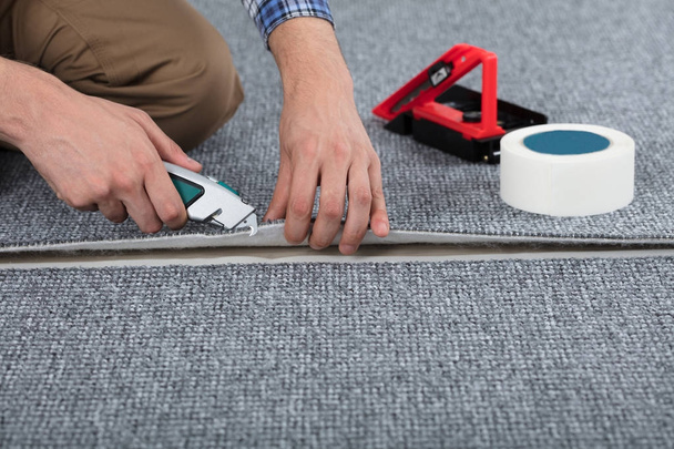 Carpenter Laying Carpet - Фото, изображение