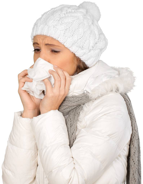Woman sneezing in a tissue - Φωτογραφία, εικόνα