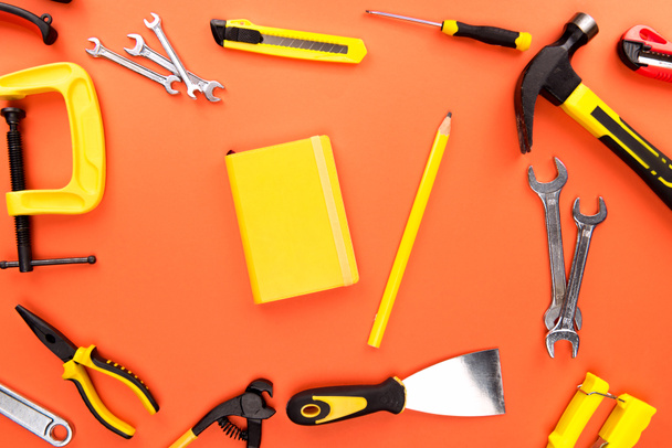 yellow notebook and reparement tools - Foto, imagen