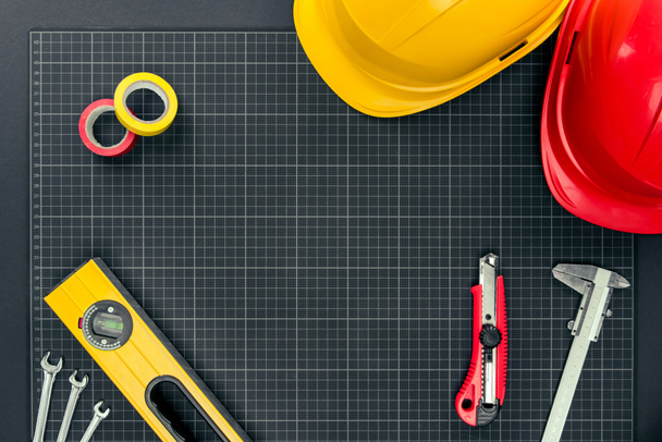 tools and hardhats on graph paper - Photo, Image