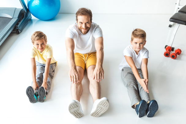 father with sons exercising together - Photo, Image