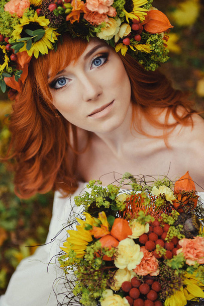 autumn portrait of romantic redhead woman with flowers in her hair in a wreath - Valokuva, kuva