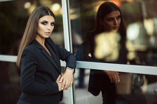 Portrait of fashion business woman near big windows - 写真・画像