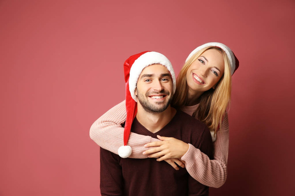 young couple in Santa hats - 写真・画像