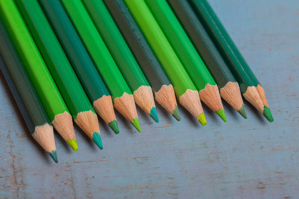 Wooden colorful pencils, on a blue old table - Фото, изображение