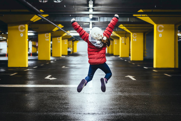 Girl jumping in the public garage - Foto, afbeelding