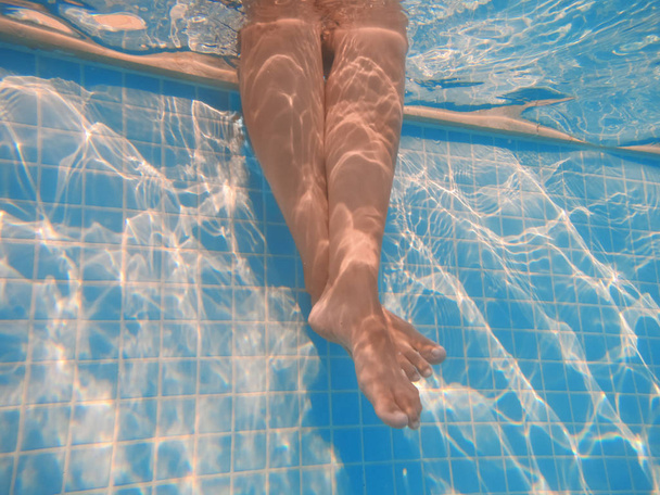 Legs of woman in pool - Foto, Imagen