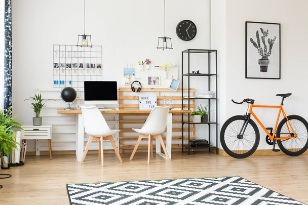 Spacious workspace with orange bike - Photo, Image