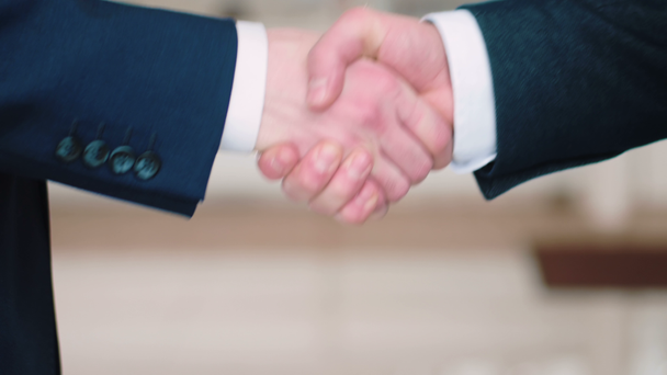 close-up of businessmen handshaking - Materiał filmowy, wideo