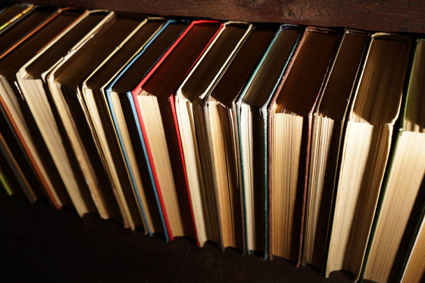  books on brown wooden bookshelf              - Фото, зображення
