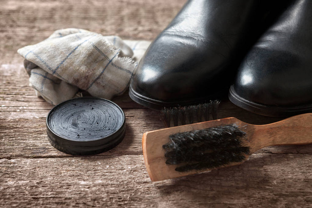 Polishing cream, brush and black boots - Foto, immagini