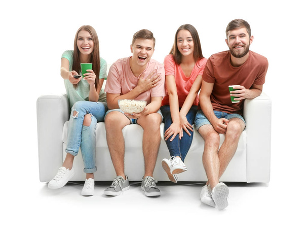Friends watching TV on sofa, isolated on white - Фото, зображення
