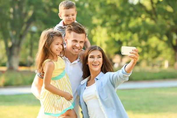 Happy family making selfie in park - Zdjęcie, obraz