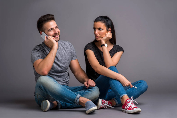 Nice young couple sitting in the studio - Фото, изображение