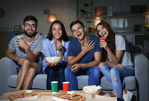 Friends watching TV in evening at home - Photo, Image