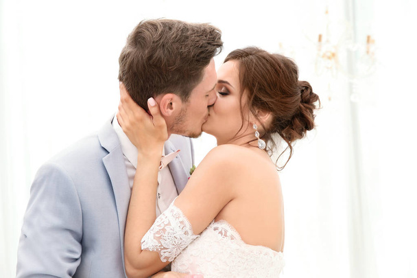 Happy beautiful couple kissing on wedding day, indoors - Fotografie, Obrázek