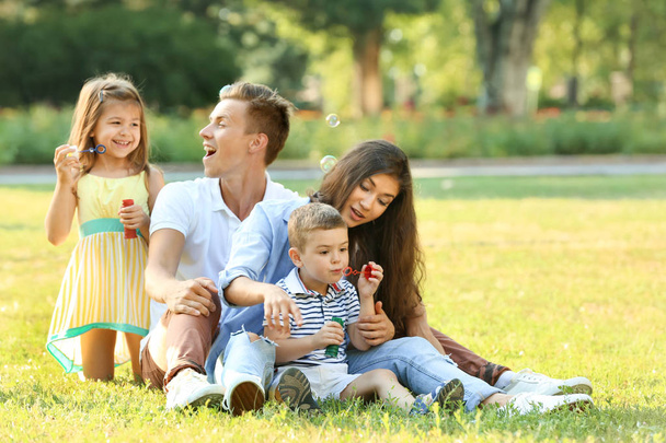 Happy family in park - Фото, изображение