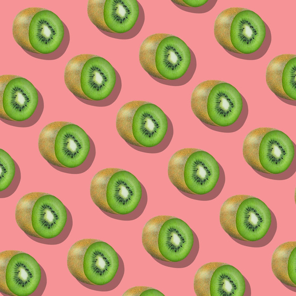 Pattern of kiwi Fruits on pink Background, similar slices - 写真・画像