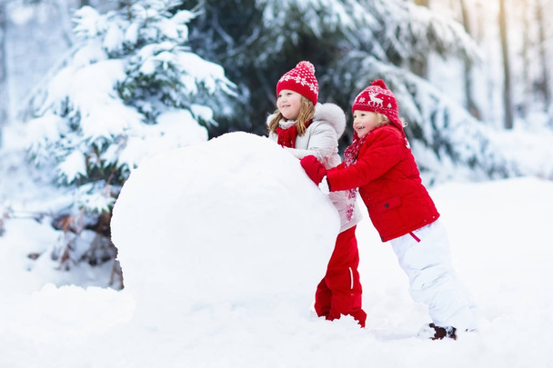 Kids building snowman. Children in snow. Winter fun. - Photo, Image