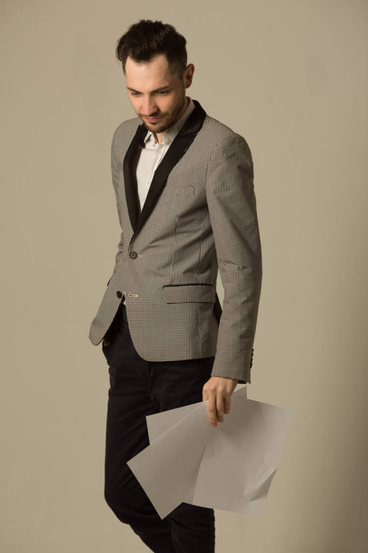 a young man in a suit with an unshaven face - Fotó, kép