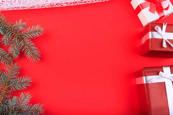 Beautiful gift boxes with a red and white bow on a red background. - Foto, afbeelding