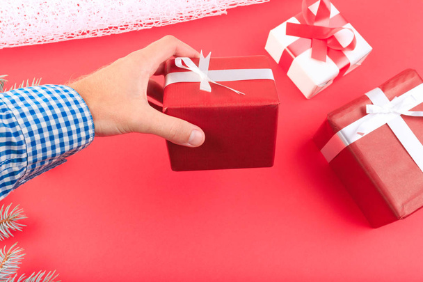 Beautiful gift boxes with a red and white bow on a red background. - Foto, immagini