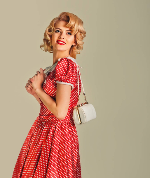 charming blonde pin-up girl with little bag - Foto, Imagen