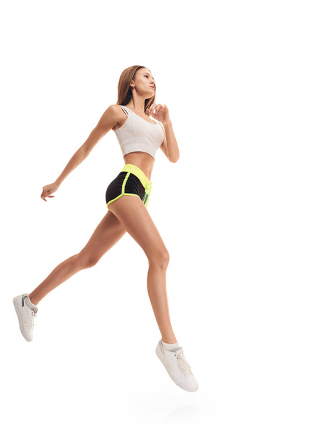 Runner woman full length. jumping - Фото, изображение