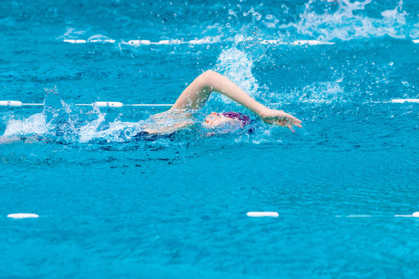 female swimmer swimming in freestyle stroke - Фото, изображение