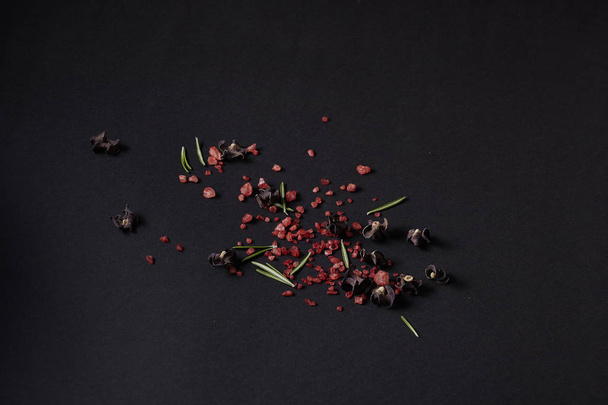Spices scattered on a black background - Photo, Image