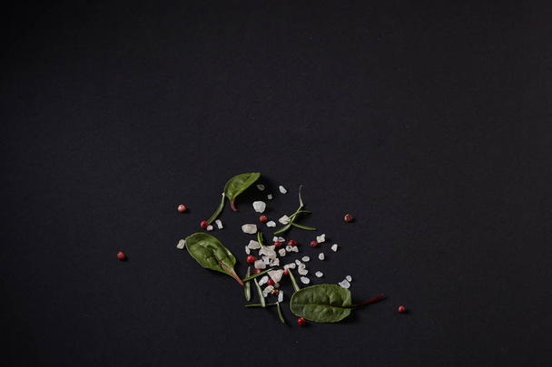 Spices scattered on a black background - Valokuva, kuva