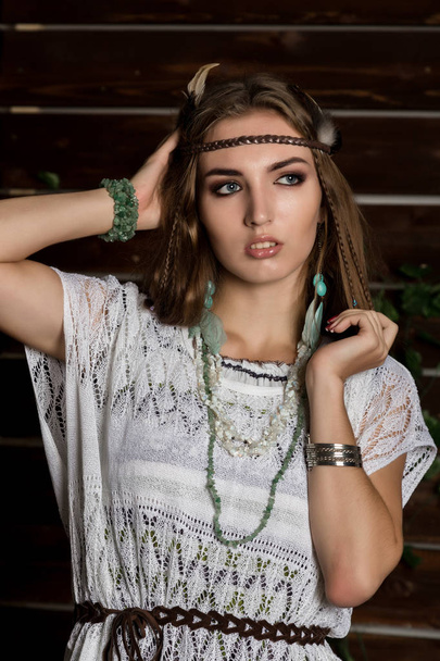 fashion young female hippie poses on a wooden wall background - Foto, Imagem