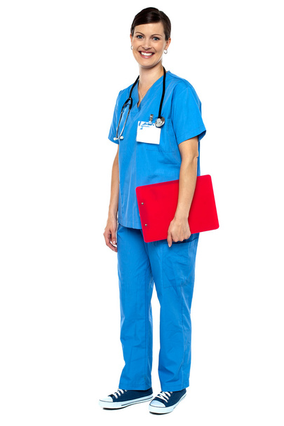 Nurse wearing blue uniform and holding red clipboard - Foto, afbeelding